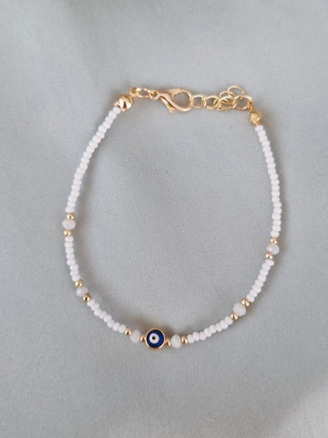 Bracelet fantaisie perles blanches et dorées œil